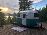 Escape to nature! This charming rv rental offers a scenic lakeside camping experience at golden hour.