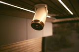 A modern, cream and copper-toned ceiling light fixture illuminates a stylish RV rental interior.