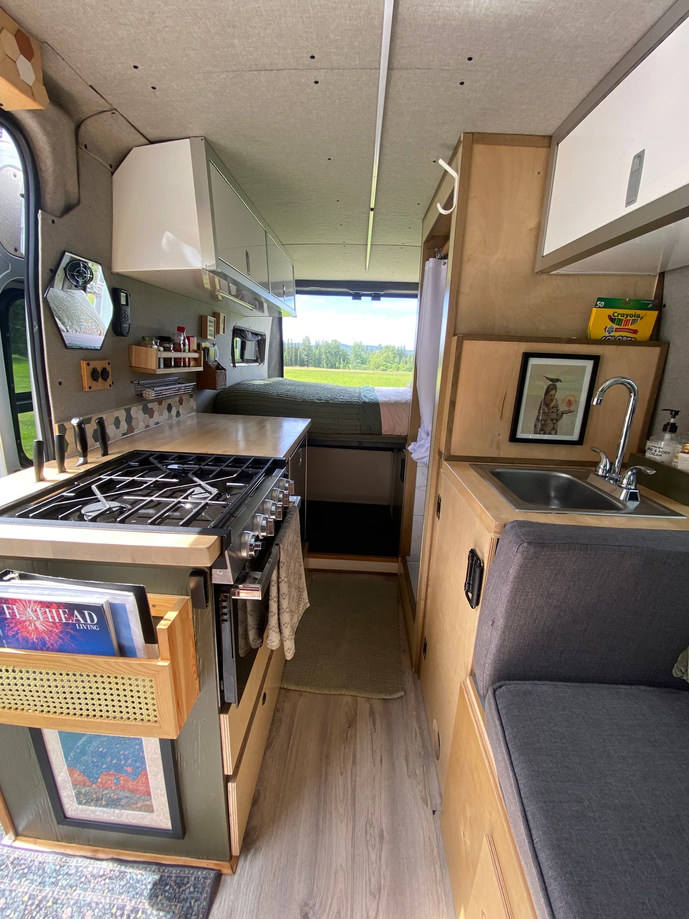  and blue sky from the open back doors.|Compact rv rental interior featuring a shower — photo 14