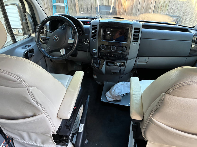  and driver's cabin in view.|This RV rental features a cozy camper van interior with a dining area — photo 8