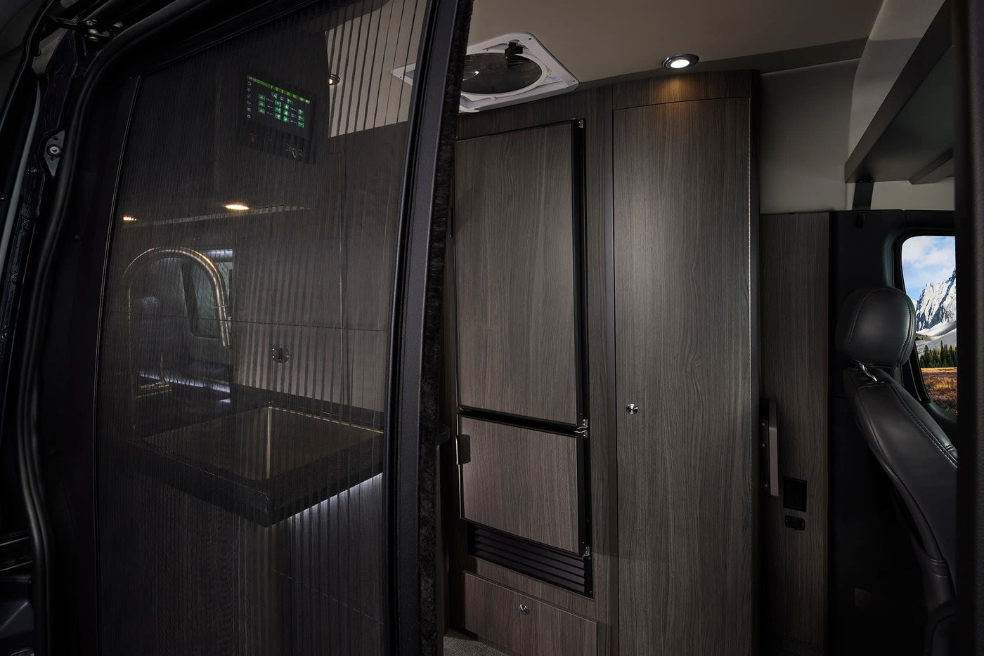 and stunning mountain views for your next adventure.|Grech RV rental interior: Mercedes-Benz front cabin with comfortable seats and a panoramic mountain landscape view.|Luxury rv rental: modern interior — photo 7