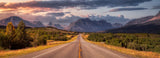 Experience the vastness: an RV rental journey on a highway through mountains, vibrant forests, and a colorful sunset sky.