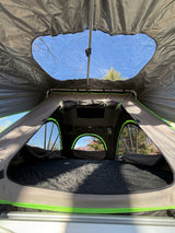 Interior of a rooftop tent. Panoramic sky views & cozy bed for your next RV rental camping adventure.
