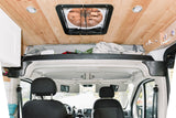 Interior view of an RV rental: wood ceiling with fan & lights, plus front cabin & clever overhead storage.
