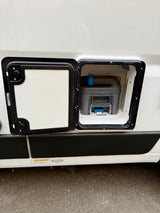 RV rental: Exterior panel open on a white RV, showing a gray cassette toilet waste tank within the compartment.