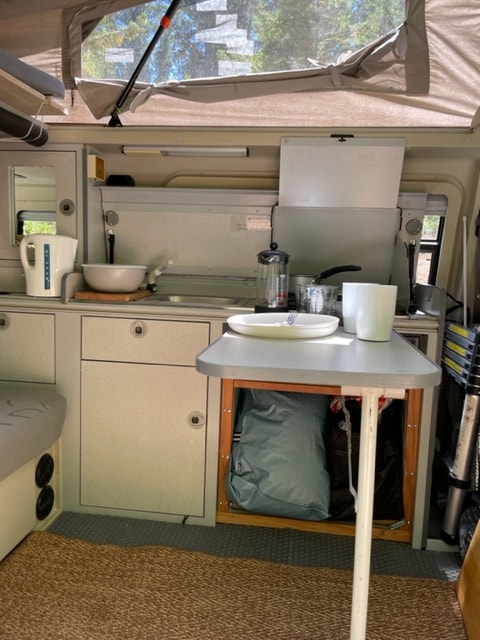  and built-in kitchenette.|RV rental interior showing compact kitchen with sink — photo 10