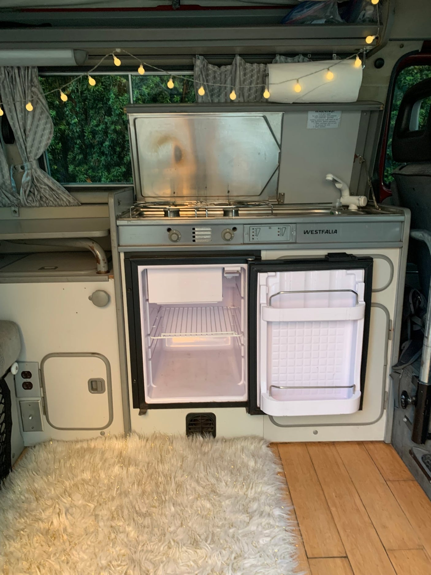  with sweeping dunes & clear blue sky. Ideal for adventure.|Maroon camper van (ideal RV rental) in a sunny parking lot. Majestic snow-capped mountains & pine trees complete this scenic travel backdrop.|Classic camper van rear view