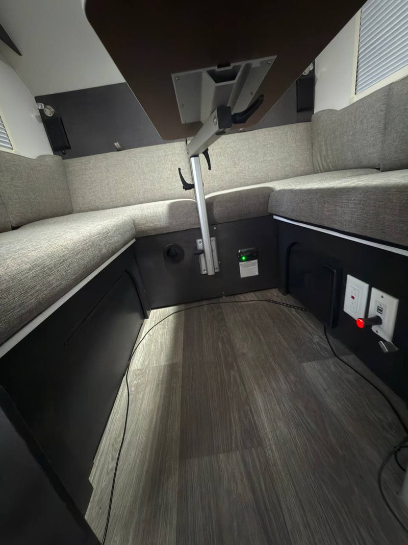  and open overhead cabinets.|Inside an rv rental: an open door reveals a backyard scene with a fence — photo 16