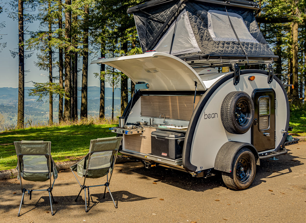 This RV rental offers a compact outdoor kitchen and rooftop tent, perfect for scenic camping adventures.