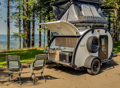 This RV rental offers a compact outdoor kitchen and rooftop tent, perfect for scenic camping adventures.