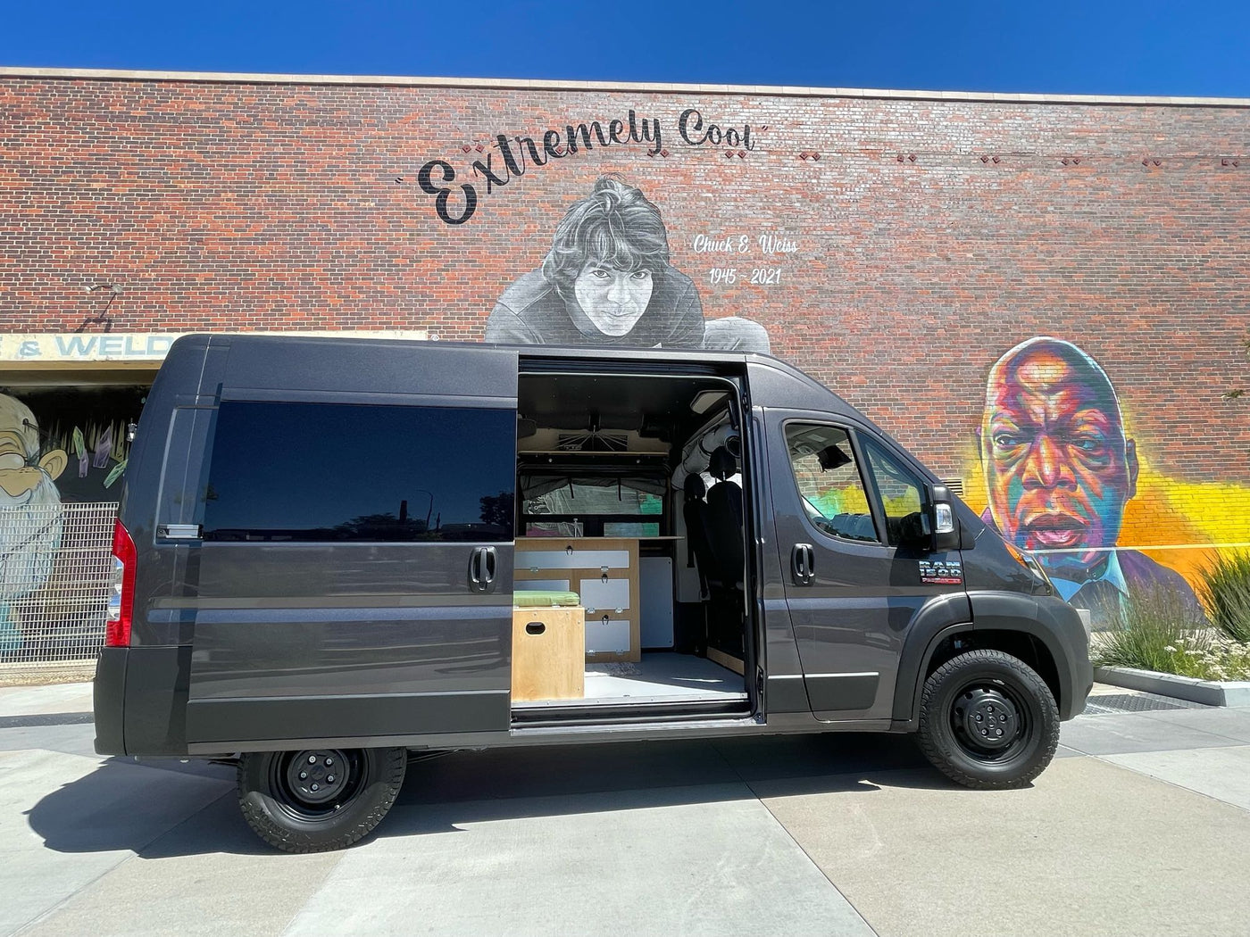  perfect for pet-friendly adventures.|Gray Ram ProMaster RV rental van beside a "big old goofy world" mural. Perfect for exploring and travel adventures!|Driver's view from an RV rental at sunrise on a snowy mountain road. Dashboard — photo 2