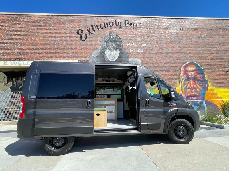  perfect for pet-friendly adventures.|Gray Ram ProMaster RV rental van beside a "big old goofy world" mural. Perfect for exploring and travel adventures!|Driver's view from an RV rental at sunrise on a snowy mountain road. Dashboard — photo 2