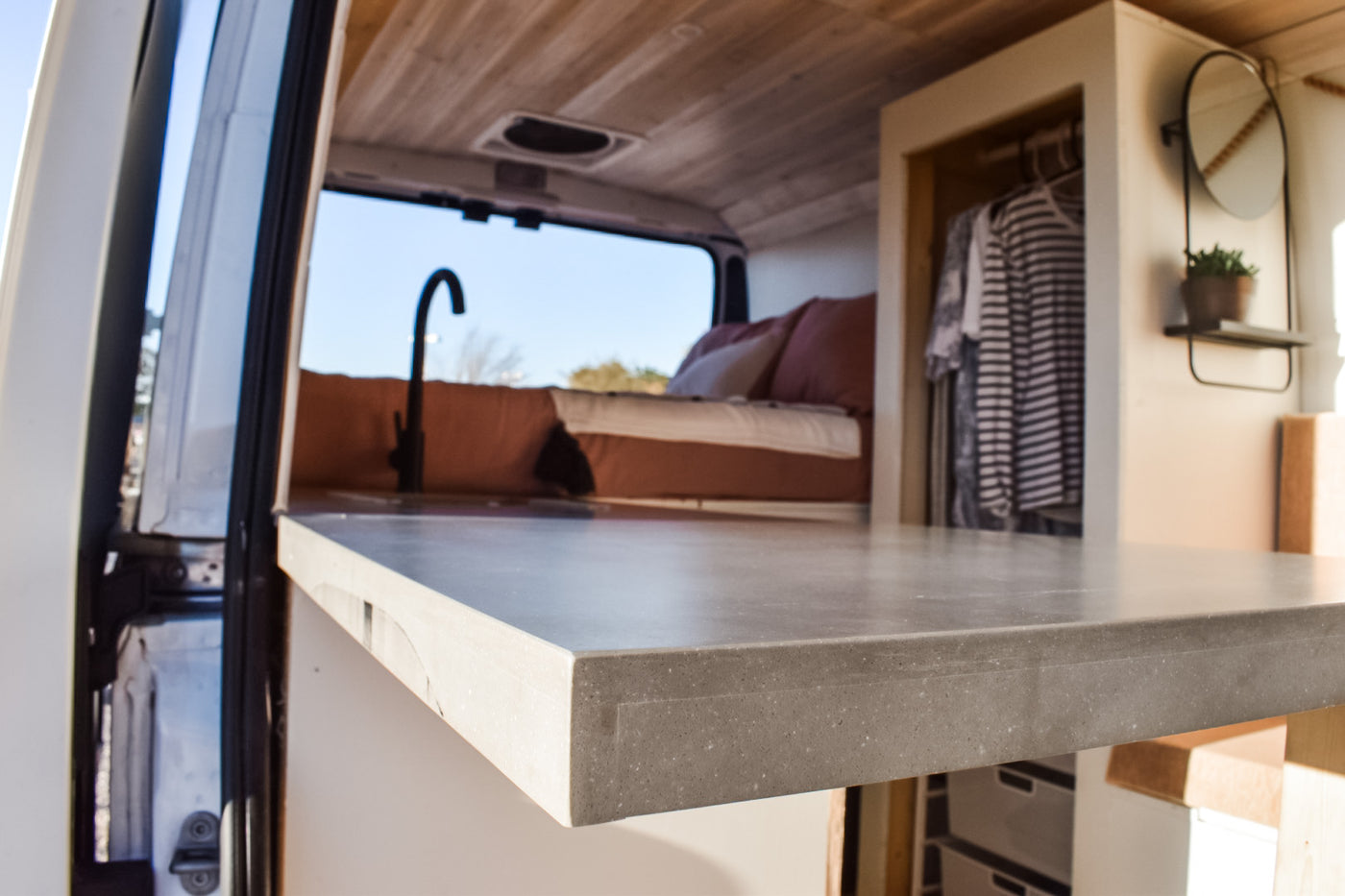 Inside a sleek RV rental: modern kitchenette, comfy bed, and built-in storage. Perfect for adventure travel. — photo 19