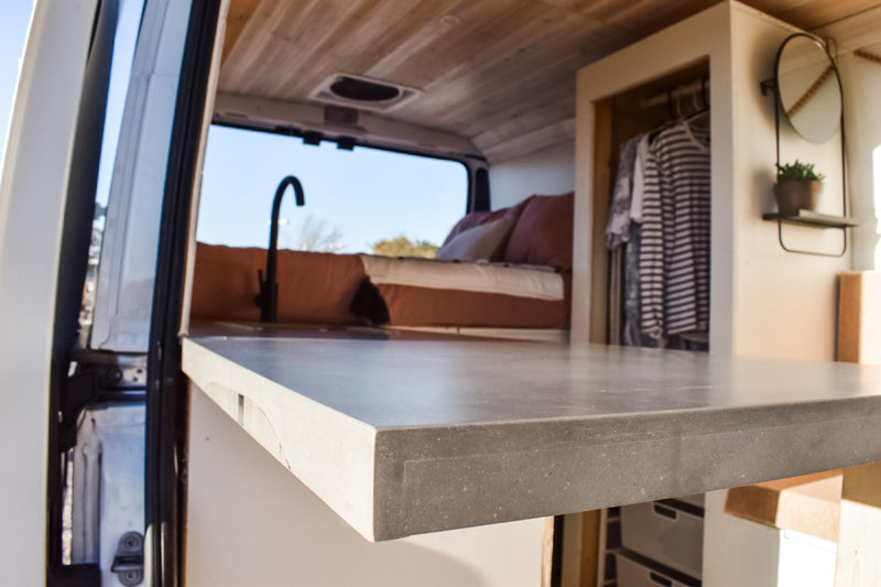 Inside a sleek RV rental: modern kitchenette, comfy bed, and built-in storage. Perfect for adventure travel. — photo 19