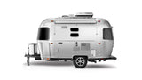 A modern, silver recreational travel trailer, often sought for rv rental, featuring distinctive oval windows and roof AC.