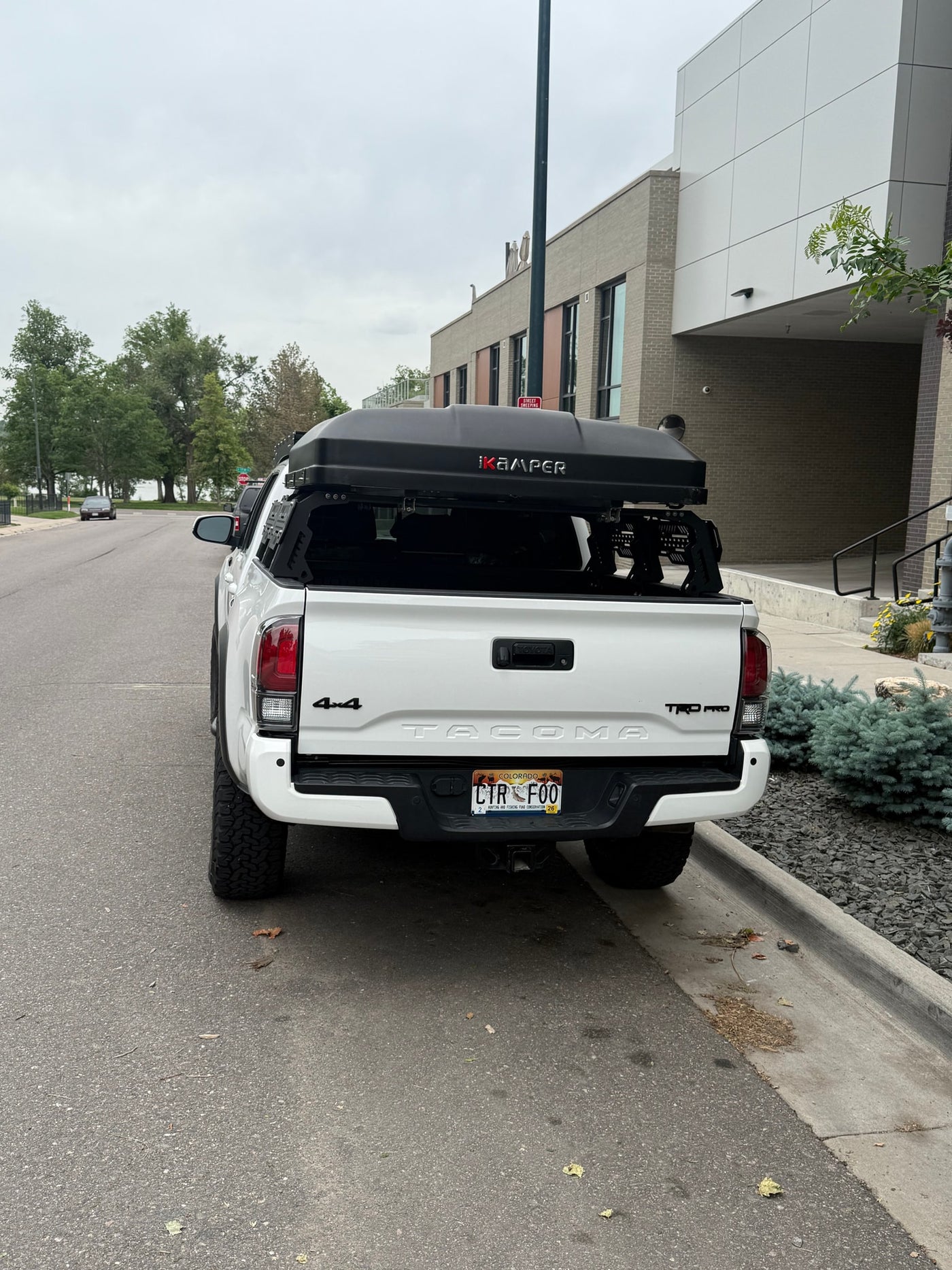 White Toyota Tacoma pickup truck, equipped with an iKamper rooftop tent, a great RV rental alternative for outdoor adventures. — photo 16
