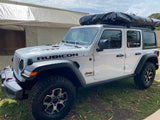 White Jeep Wrangler Rubicon with rooftop tent, ideal for an RV rental adventure.