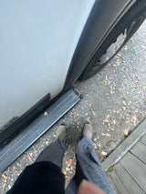 Standing by an rv rental van, with feet on gravel next to the vehicle's side step. Time to explore!