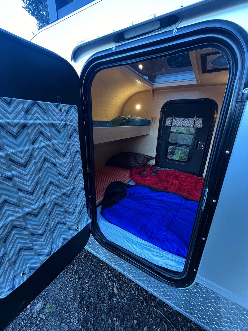  on the back of an RV rental. Perfect for camper travel!|Compact silver teardrop camper for your next RV rental adventure. Features awning — photo 16