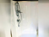 Clean RV rental bathroom shower with an adjustable head, ideal for comfortable travels.