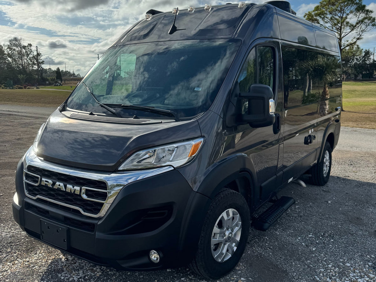  parked on gravel for travel.|This dark grey Ram ProMaster camper van — photo 5