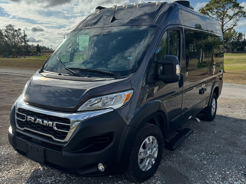  parked on gravel for travel.|This dark grey Ram ProMaster camper van — photo 5