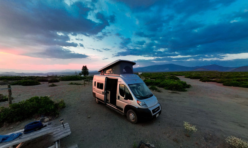  ready for adventure.|Experience outdoor travel with an RV rental! Modern pop-top camper van on a gravel road — photo 8