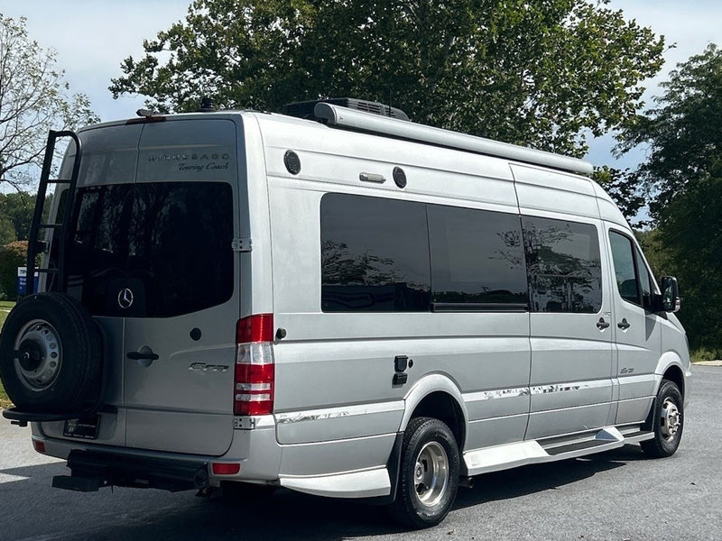  and dashboard.|This RV rental offers a bright Mercedes Sprinter cockpit with tan seats — photo 8