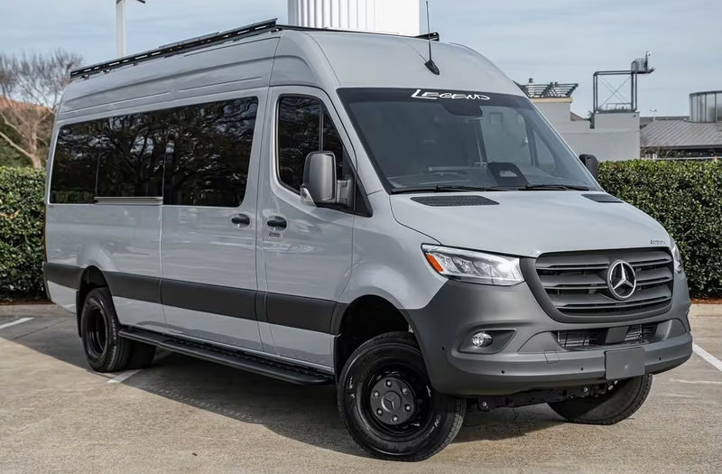 A gray Mercedes-Benz Sprinter RV rental, an adventure-ready camper van with black off-road tires and a roof rack. — photo 1