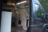 Inside an RV rental: Comfortable captain's chairs in a modern camper van's front cabin.