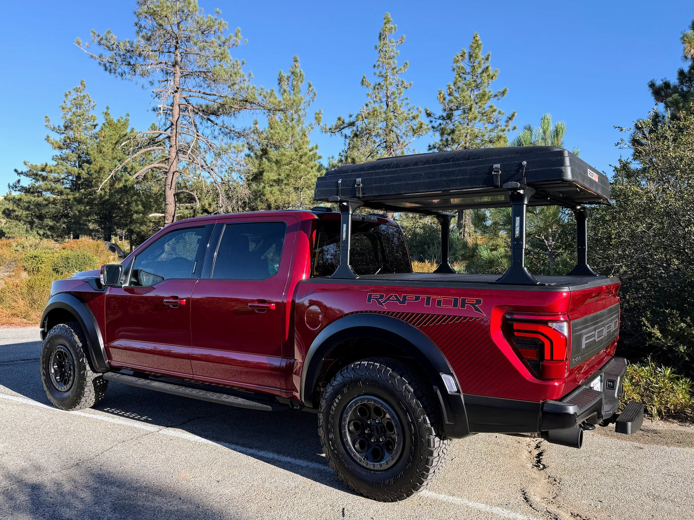  perfect for an RV rental trip or adventure.|Red Ford Raptor pickup with an overlanding roof-top tent — photo 14
