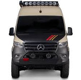 Front view: A tan & black Mercedes Sprinter adventure van, perfect for RV rental. Features off-road tires, bull bar & rooftop lights.
