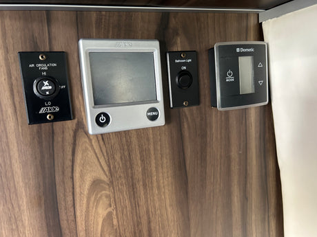 RV rental interior showing Alde and Dometic climate and lighting controls. Useful for visually impaired guests.