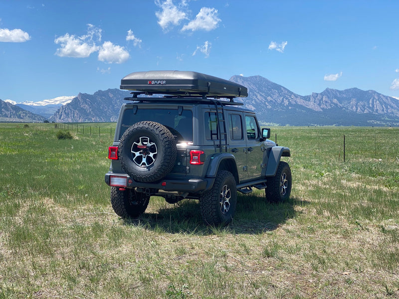  an ideal setup for an RV rental experience in the scenic mountains.|Grey Jeep Wrangler with roof-top tent — photo 2