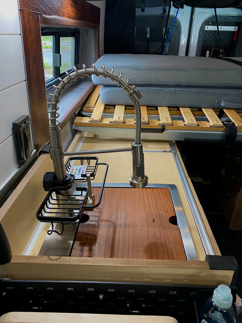  and entertainment monitors. Perfect for your next adventure!|An RV rental van at a rugged desert campsite with a picnic table — photo 11