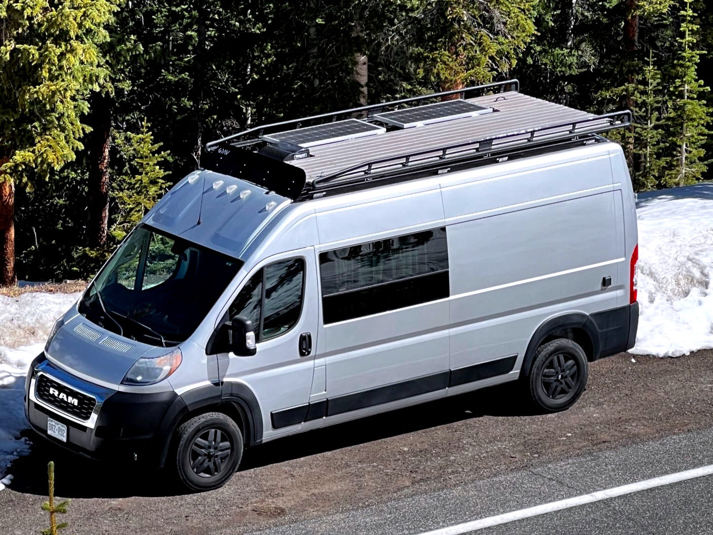 Adventure awaits in this silver Ram ProMaster camper van, ideal for RV rental and off-grid van life with solar power.
