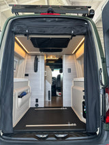 Discover this RV rental's spacious camper van interior! Organized storage, bright LEDs, and versatile tie-downs for adventure.