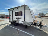 Explore the outdoors! This light gray Sportsmen Classic travel trailer, perfect for your next RV rental, is ready for adventure.