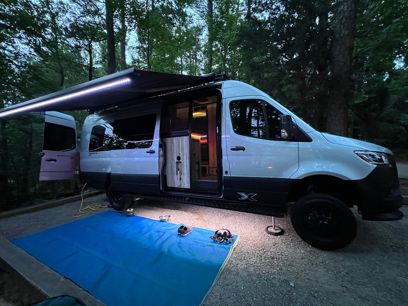  ready for outdoor living.|Beachfront RV rental setup: An Airstream van parked — photo 8