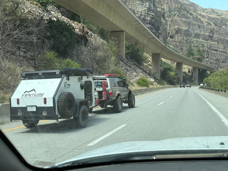 Adventure-ready RV rental setup: An off-road SUV tows a Venture Overland camper through scenic mountains. — photo 12