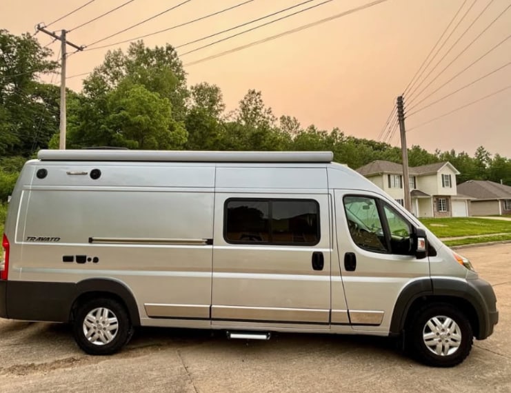 and wooden storage.|Modern RV rental kitchenette featuring a light-colored countertop — photo 2