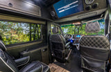 Luxury rv rental interior with plush quilted seats, wood trim, and a screen displaying a Netflix error. Perfect for travel comfort.