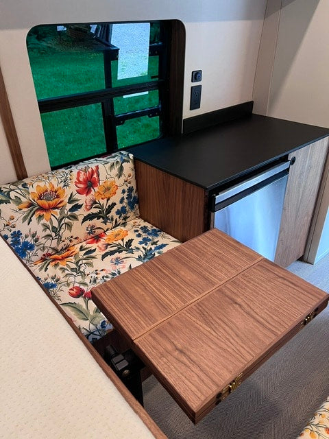  and storage for van life comfort.|RV rental interior: Floral wall with power outlet — photo 9