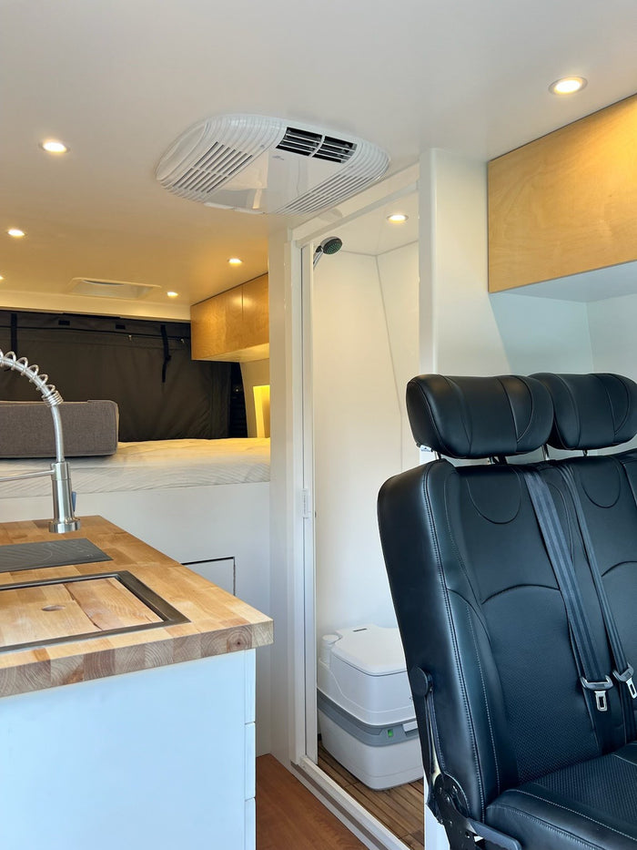  and versatile seating area. Bright and functional for travel.|Modern rv rental interior: compact kitchen with sink