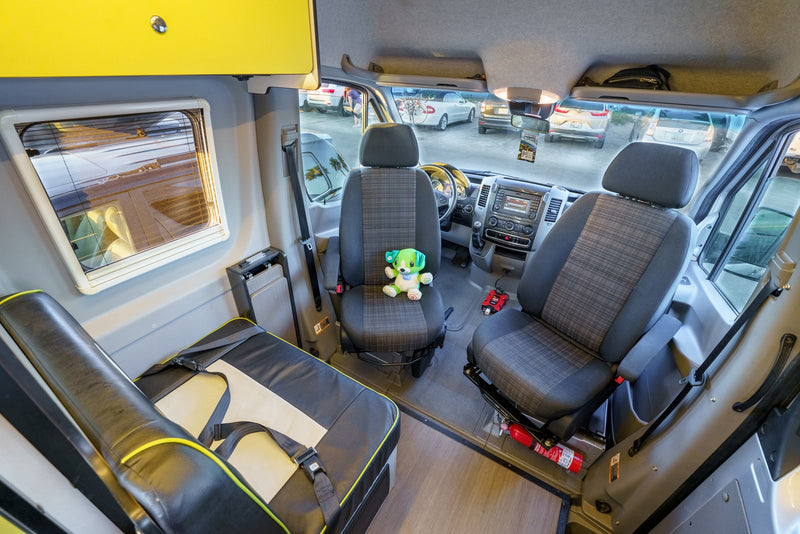 A detailed look inside an RV rental, featuring front driver/passenger seats, a rear bench, and the dashboard. — photo 15
