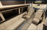 Spacious RV rental interior: cream leather sofa & captain chairs, diamond-stitched, with an entertainment screen.
