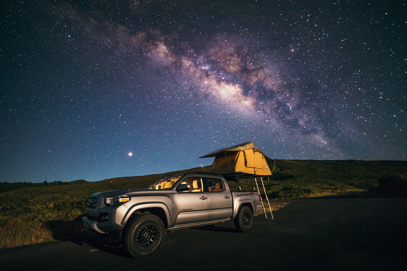 Stargaze from your RV rental! A Tacoma truck with rooftop tent under the vibrant Milky Way, ideal for remote camping.