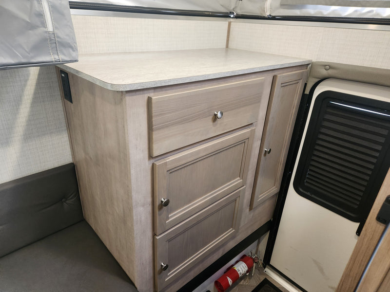  and dining area with blinds.|Cozy RV rental interior with an elevated bed — photo 6