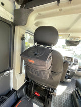 RV rental interior featuring a black car trash can securely mounted on the passenger seat headrest, promoting tidy travel.