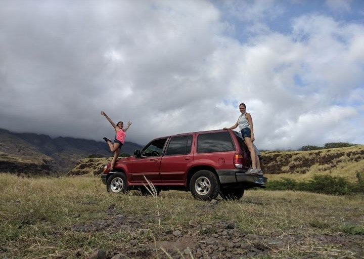  no RV rental needed for this fun!|Smiling woman relaxes by her SUV at sunset. This outdoor setup highlights fun travel options like an RV rental.|Man preparing food by a car camping setup with mountains & sand. Ideal for an outdoor adventure — photo 4